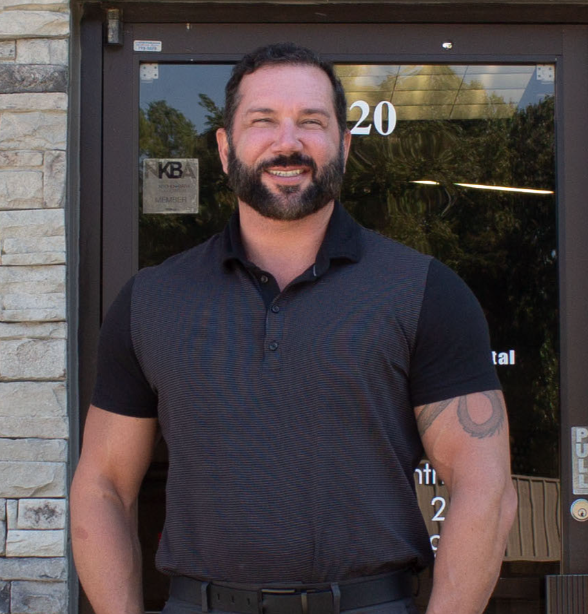 Justin Herter standing in front of office door